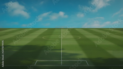 Empty football pitch with goal, striped grass, midfield line, and blue sky with clouds