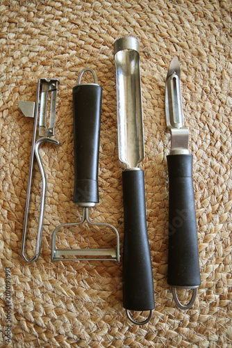 Kitchenware: stainless steel with serrated blade knives to peel and carve vegetables on natural background