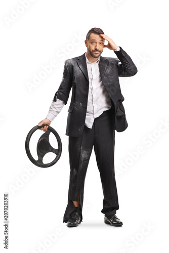Shocked driver in a ripped suit holding a steering wheel