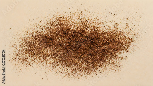 Scattered ground vanilla bean powder on a light surface