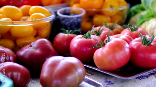 pink tomatoes farmer puts on the counter Various vegetables harvest