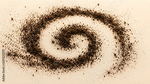 Dark vanilla powder in a spiral shape on a neutral background