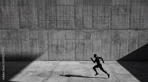 Athlete sprinting past a massive concrete wall casting a long dramatic shadow in monochrome