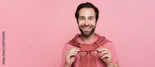 Obraz na plátne Handsome man in elegant summer attire radiates joy and style against a vibrant b