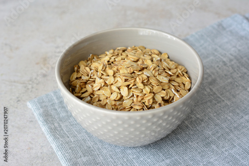 Bowl of Dry Rolled Oats on a Light Blue Napkin