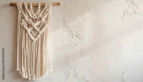 Boho chic macrame wall hanging on textured plaster wall
