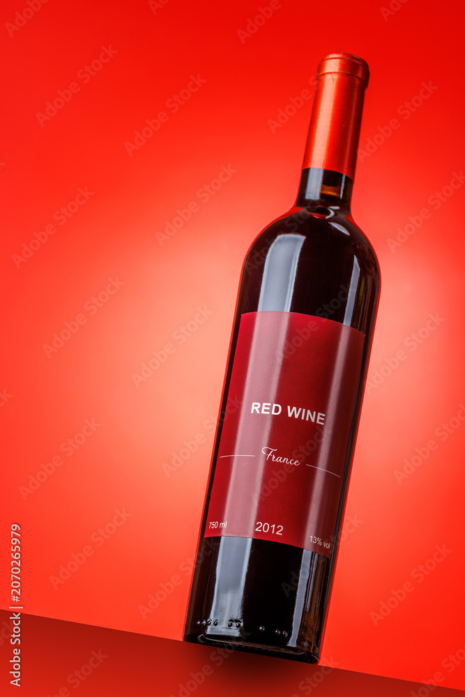 Fototapeta premium Red wine bottle mockup on red background