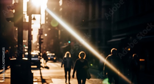 Backlit pedestrians on a sunlit city street at sunset.