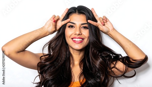 Smiling Young Woman Making Peace Signs Near Her Head in Studio Background