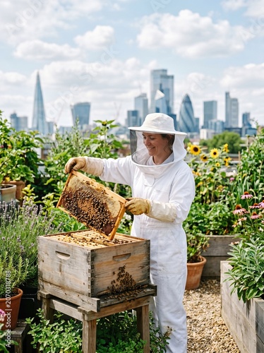 Urban Rooftop Beekeeper Lifting Honeycomb Frame from Hive Box in City