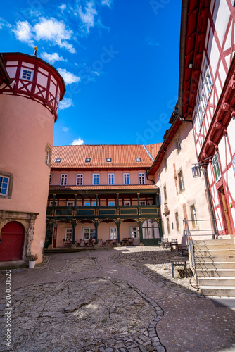Charming red building with decorative details, Picturesque artisan shop with ornate features and inviting atmosphere