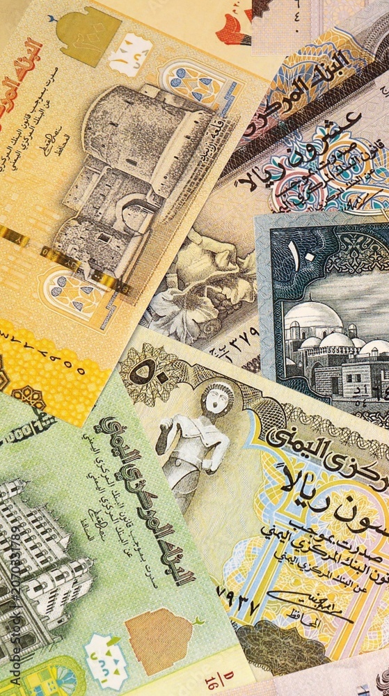 Fototapeta premium Yemeni rial money bills in pile on table. Yemen YER currency cash close up