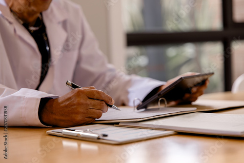 Obraz na plátně reviewing patient records and using a digital tablet in a healthcare office