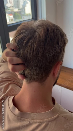Close-up of a person scratching the back of the head, expressing confusion, uncertainty, thinking or searching for an answer. Human behavior concept representing doubt, problem solving