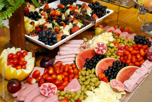 Sophisticated charcuterie board with assorted cheeses cold cuts and fresh fruits for events