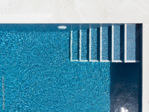 Aerial View of Modern Swimming Pool with Blue Water and Tile Steps