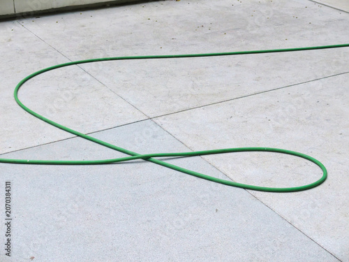 green hose for washing in the garden