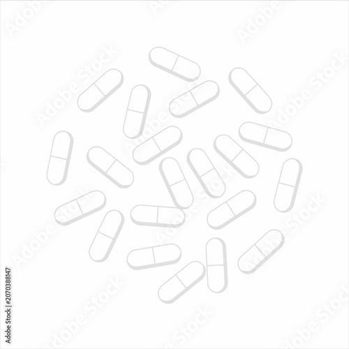 Medical capsules lie scattered on a clean white surface