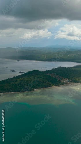 Aerial view of coastline of Borneo island with beach and jungle. Malaysia. Vertical video.