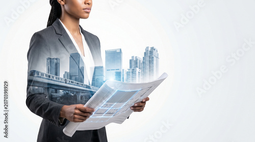 Female Engineer With Folded Plans And Urban Double Exposure