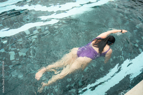 Plus Size Woman Swimming in Pool for Fitness and Healthy Lifestyle