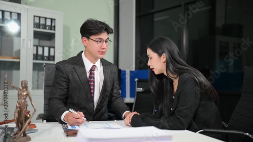 Asian attorney offering support and legal advice to a distressed woman during an office