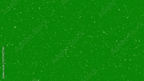 Animated realistic small snowflakes falling densely and slowly through air against on green background. thousands of small snowflakes floating naturally in cold air, 4k video