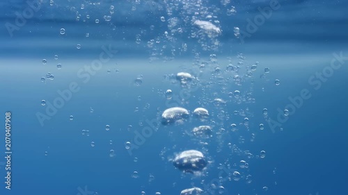 Bubbles rising through clear blue water, creating a serene underwater atmosphere. Represents tranquility and the beauty of aquatic environments