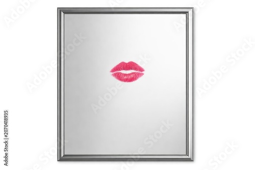 A mirror with a lipstick imprint, suggesting a hasty departure or surprise