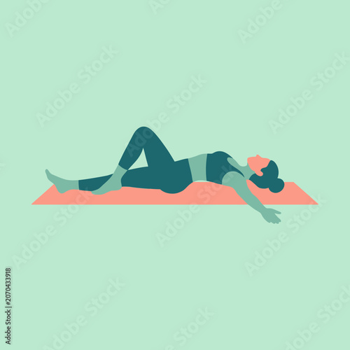 A woman performs a relaxing yoga stretch on a pink mat