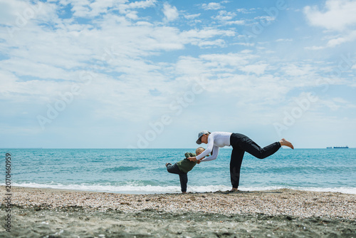 Playful moment on the beach with a child and adult enjoying a sunny day by the water