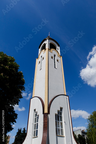 The Cathedral of Saints Peter and Paul in Chortkiv stands out with its contemporary architectural design, elegant central dome, and bright blue sky backdrop.