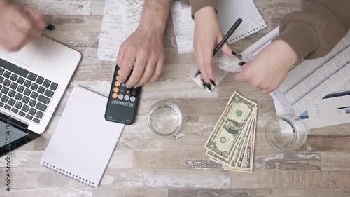 Collaborative team calculating monthly expenses and managing budget at office desk finance calculator money accounting business