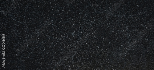 Black granite texture with white speckled mineral details, dark natural stone surface, polished charcoal marble background for luxury interior design
