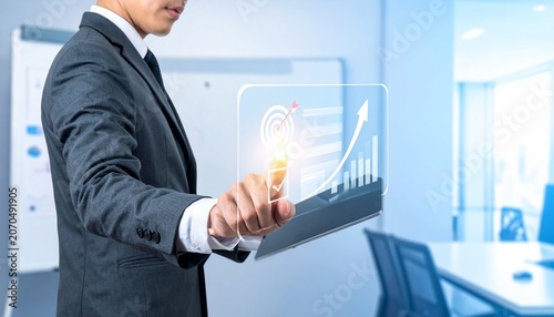 Corporate businessman working with holographic business data and growth chart projection in bright modern office space