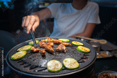 Grilling Chicken and Vegetables on a Korean BBQ Table with Steam