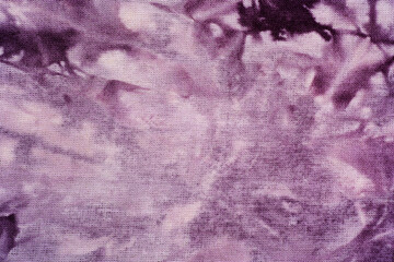 Macro view of purple tie dye fabric texture