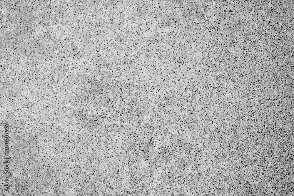 Fototapeta premium Rough gray concrete surface texture background with small dark speckles and granular details