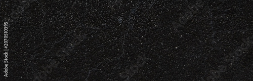 Vintage film grain texture on black background, dusty cinematic overlay for video editing, dark gritty paper surface with white speckles