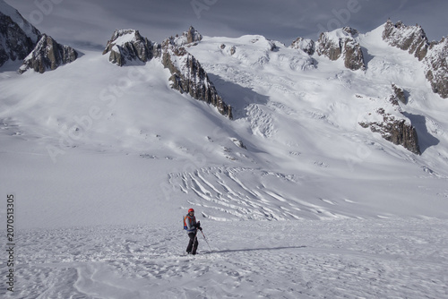 Single female skier overlooking Glacier du Geant in the Mont Blanc massif