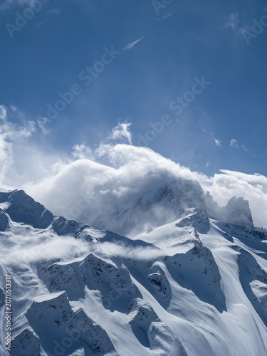 Aiguille Vert in stormy clouds in winter