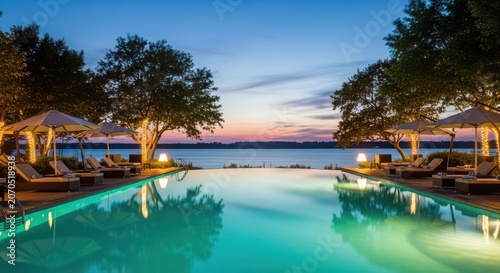 Infinity pool with sunset and palm trees at dusk poolside