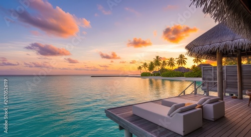 Sunset view over turquoise lagoon with overwater bungalow and palm trees turquoise water
