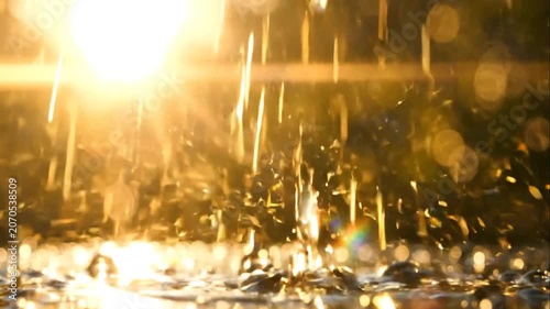 Rain falling on sunny day outdoors.