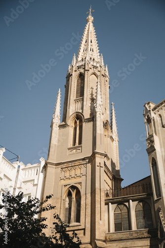 Valencia, Spain - June 12, 2026: Neo-Gothic church tower rising above historic buildings in the city center of Valencia, Spain.