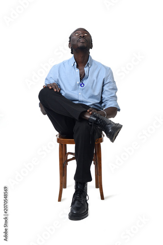 front view of a man sitting on chair look up and cross legged  on white background