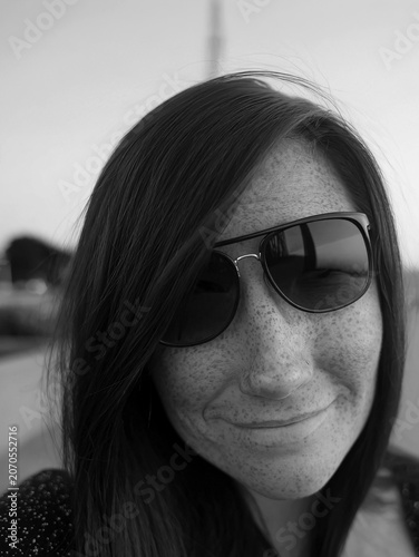 Beautiful  Woman Taking a Sunset Selfie on a Seaside Boardwalk