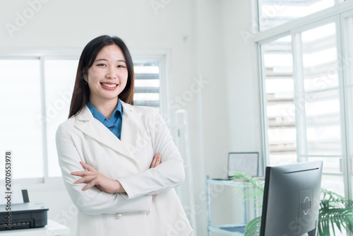 Young Businesswoman Working at Office Desk While Managing Documents and Mobile Communication.
