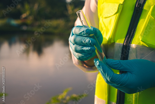 Water quality inspector collecting samples for testing and analysis to ensure safe and clean water resources.