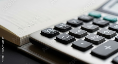Close-up view of calculator buttons and keys, highlighting numerical input for calculations